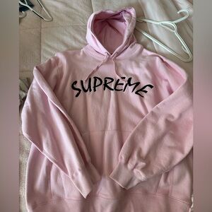 Supreme pink hoodie with red logo tag